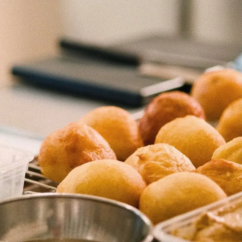 Round golden buns on a rack in the kitchen